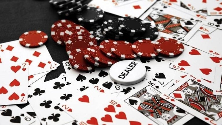 Dealer at blackjack table with side-view camera angle